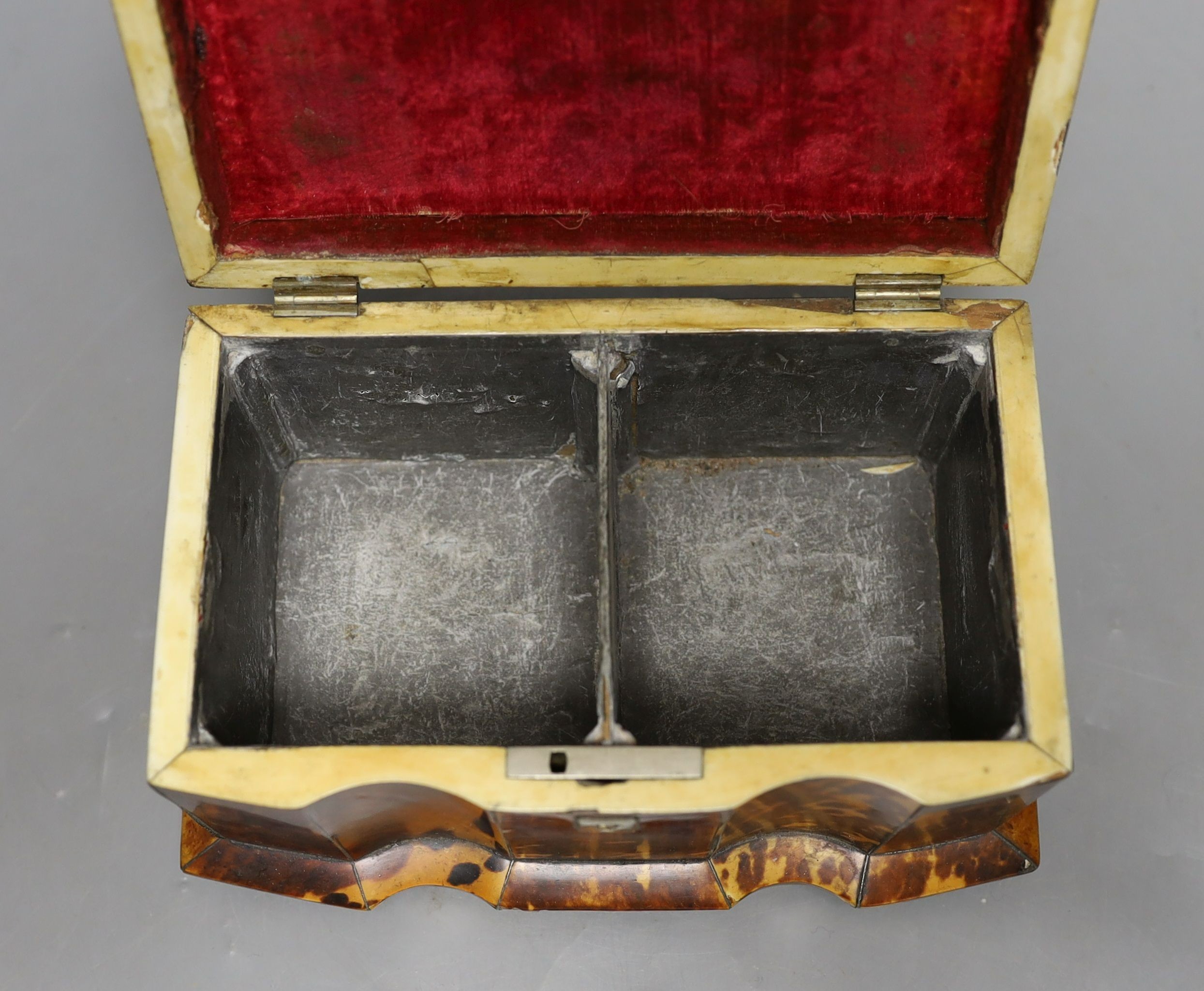 A 19th century tortoiseshell veneered tea caddy, ivory veneered edging, 20cms wide